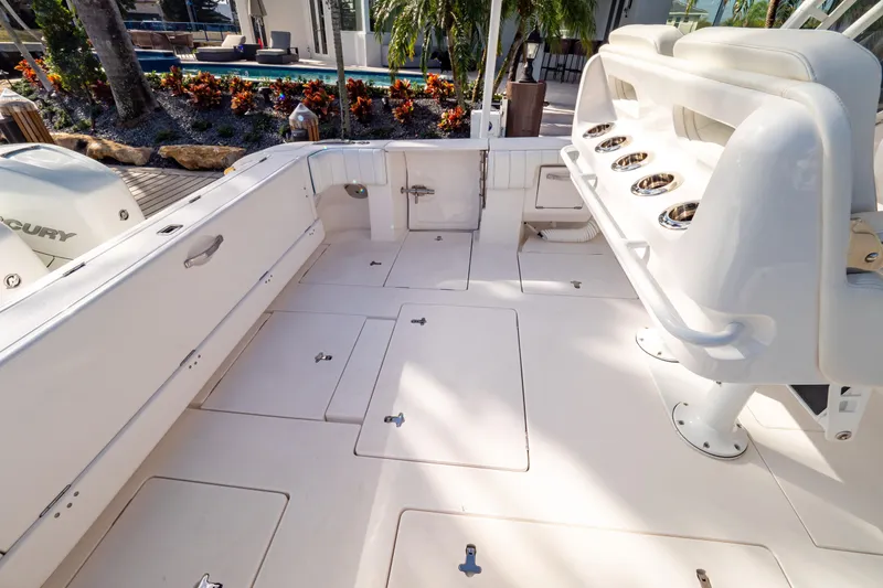 Slide: The Image of 2019 Intrepid 407 Cuddy boat deck with seating and storage compartments. - 55