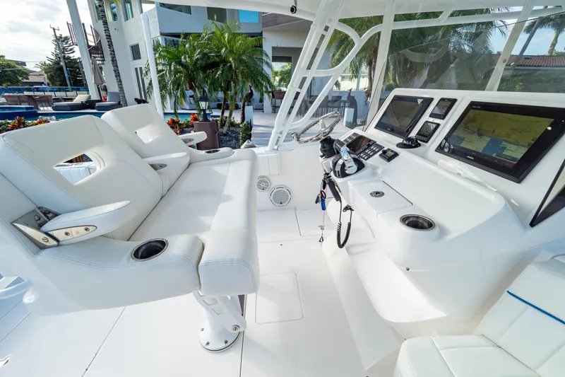 Slide: The Image of 2019 Intrepid 407 Cuddy boat interior with modern helm and seating. - 56