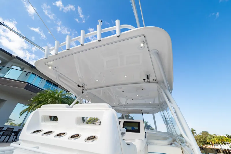 Slide: The Image of 2019 Intrepid 407 Cuddy boat with sleek design and modern features under a clear blue sky. - 57
