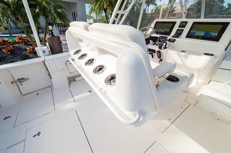 Slide: The Image of 2019 Intrepid 407 Cuddy boat interior with helm, seating, and navigation displays. - 58