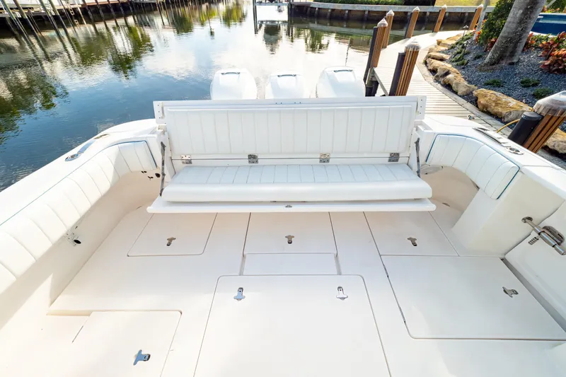Slide: The Image of 2019 Intrepid 407 Cuddy boat with spacious seating and storage, docked by calm waters. - 61