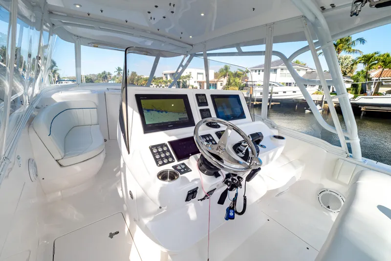 Slide: The Image of 2019 Intrepid 407 Cuddy boat cockpit with modern navigation equipment and luxurious seating. - 65