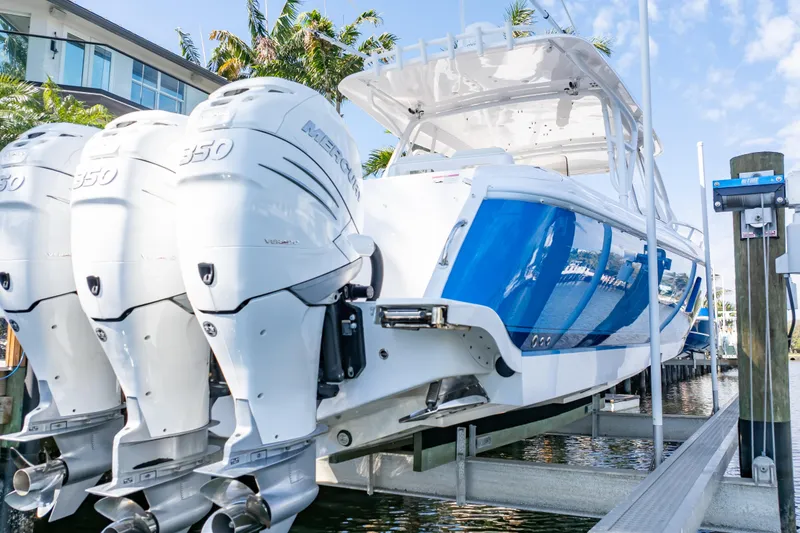 Slide: The Image of 2019 Intrepid 407 Cuddy boat with triple Mercury 350 engines on a lift. - 7