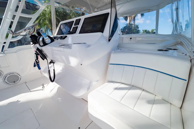 Slide: The Image of 2019 Intrepid 407 Cuddy boat interior with white seating and modern dashboard. - 70