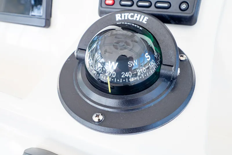 Slide: The Image of Compass on 2019 Intrepid 407 Cuddy boat dashboard, showing navigation directions. - 80
