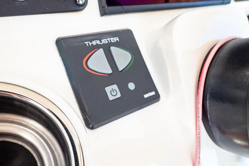 Slide: The Image of Control panel of a 2019 Intrepid 407 Cuddy boat, featuring thruster buttons. - 84