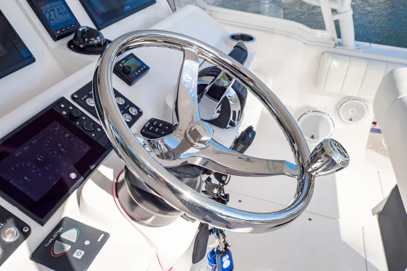 Slide: The Image of Steering wheel and controls of 2019 Intrepid 407 Cuddy boat cockpit. - 86