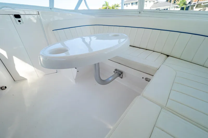 Slide: The Image of 2019 Intrepid 407 Cuddy interior with white seating and table. - 91