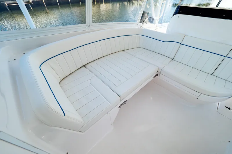 Slide: The Image of Luxurious white seating on 2019 Intrepid 407 Cuddy boat, overlooking serene water. - 93