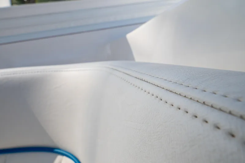 Slide: The Image of Close-up of white leather upholstery on a 2019 Intrepid 407 Cuddy boat. - 98