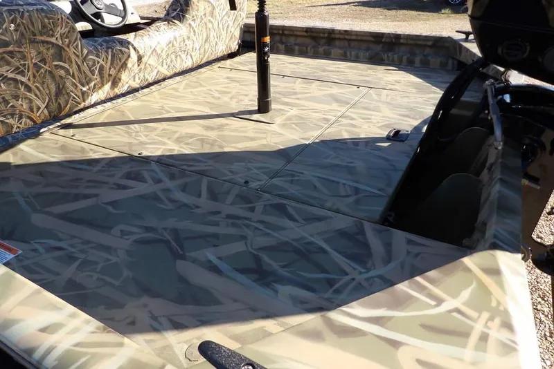 Slide: The Image of 2026 Crestliner 1860 Retriever SC boat with camouflage interior design. - 10