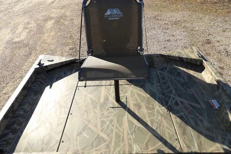 Slide: The Image of 2026 Crestliner 1860 Retriever SC boat with camo pattern and a mounted chair. - 13