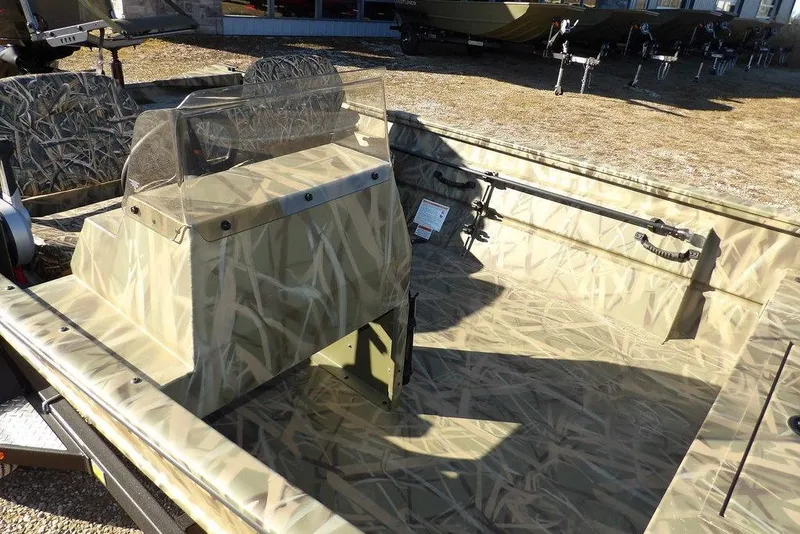 Slide: The Image of 2026 Crestliner 1860 Retriever SC boat with camouflage interior, parked outdoors. - 16