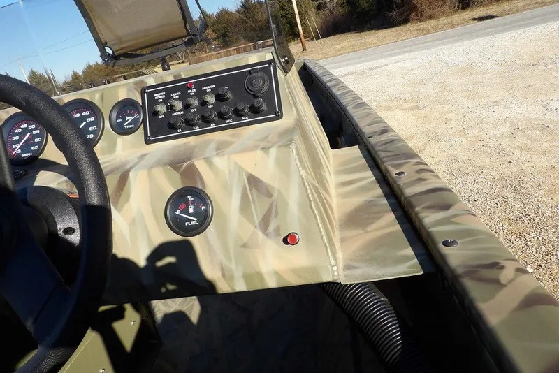 Slide: The Image of 2026 Crestliner 1860 Retriever SC dashboard with camouflage design and control panel. - 17