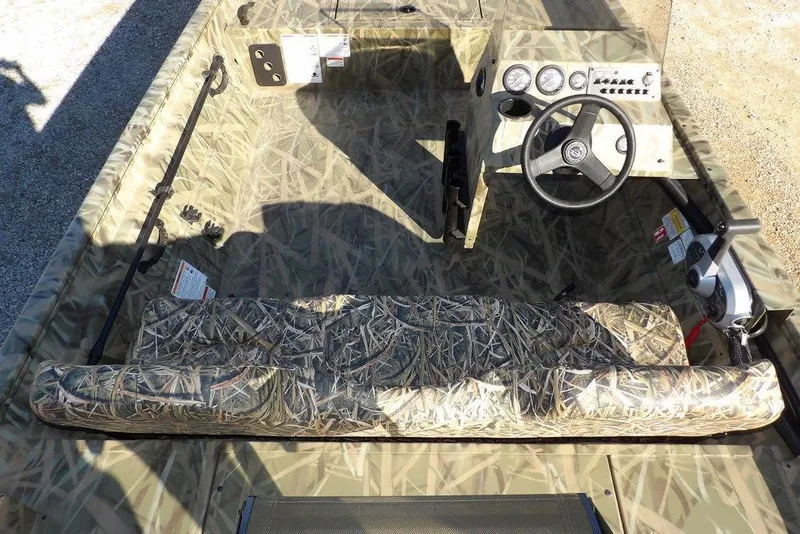 Slide: The Image of 2026 Crestliner 1860 Retriever SC boat interior with camouflage design and steering console. - 18