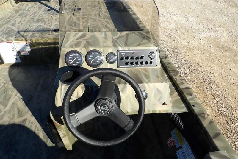 Slide: The Image of 2026 Crestliner 1860 Retriever SC boat dashboard with steering wheel and control panel. - 21