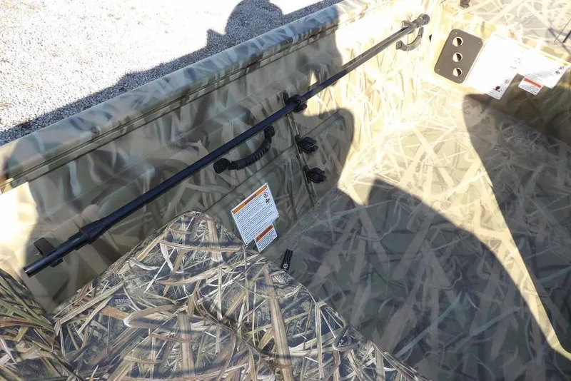 Slide: The Image of 2026 Crestliner 1860 Retriever SC interior with camouflage design and mounted accessories. - 22