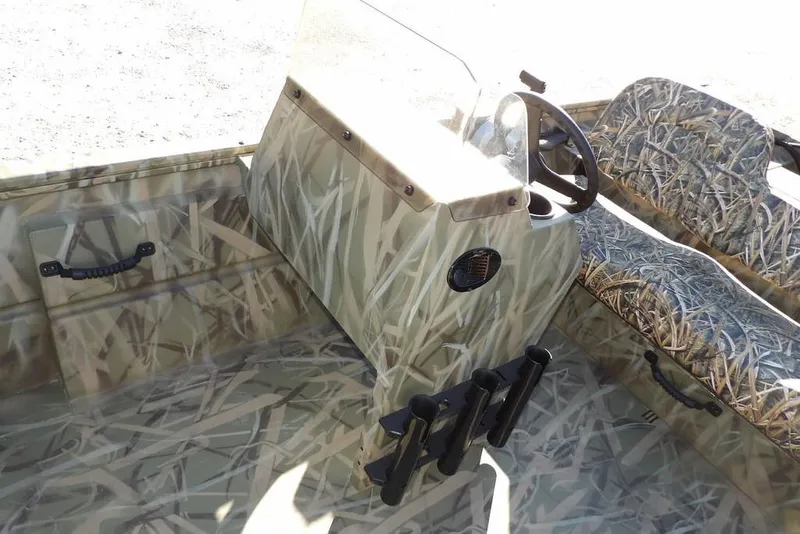 Slide: The Image of 2026 Crestliner 1860 Retriever SC boat interior with camouflage design and steering console. - 26