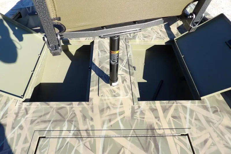 Slide: The Image of 2026 Crestliner 1860 Retriever SC boat storage compartments with camo design and adjustable seat. - 29