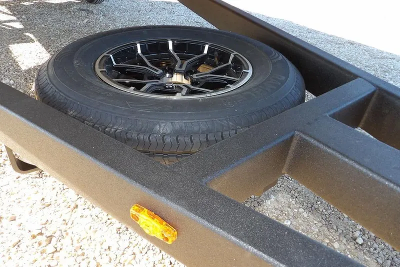 Slide: The Image of 2026 Crestliner 1860 Retriever SC trailer with spare tire on gravel surface. - 35