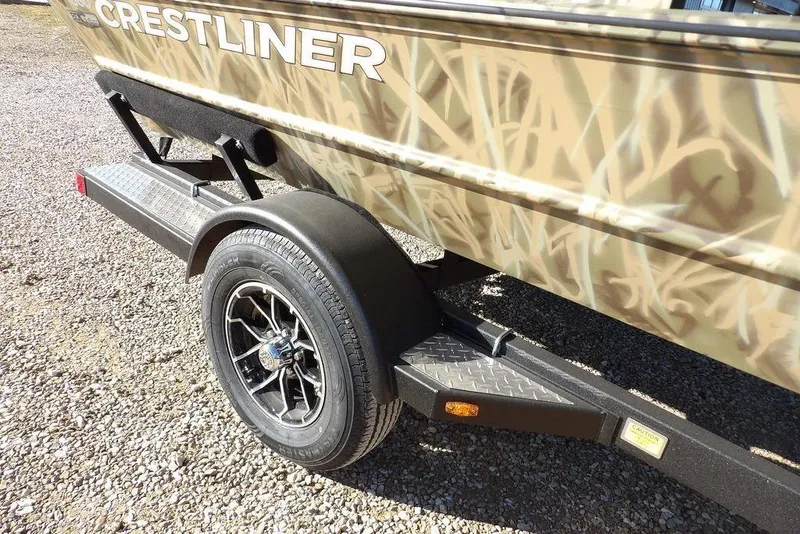 Slide: The Image of 2026 Crestliner 1860 Retriever SC boat on trailer with camouflage design. - 36