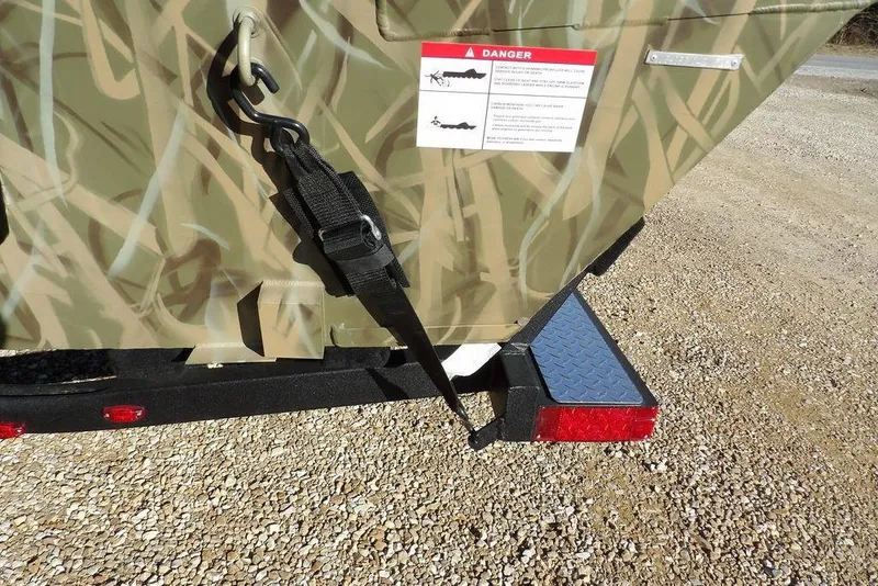 Slide: The Image of 2026 Crestliner 1860 Retriever SC boat with camouflage design and safety warning label. - 37