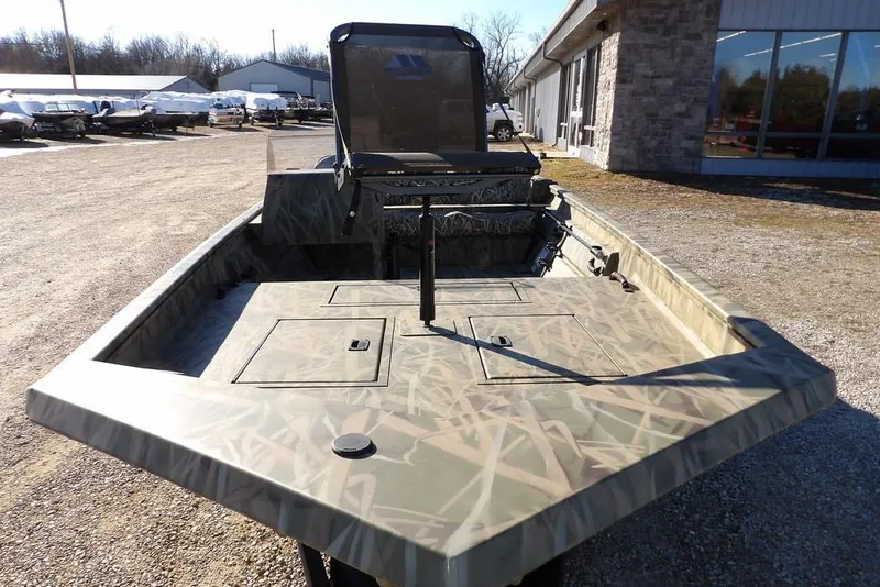 Slide: The Image of 2026 Crestliner 1860 Retriever SC boat with camouflage design, parked outdoors. - 4