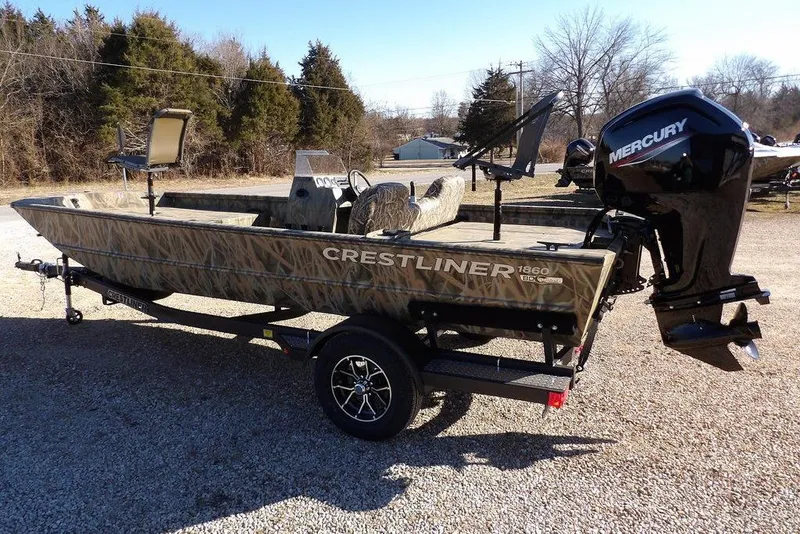 Slide: The Image of 2026 Crestliner 1860 Retriever SC boat with Mercury engine on trailer, outdoors. - 5