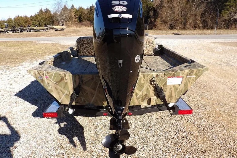 Slide: The Image of 2026 Crestliner 1860 Retriever SC boat with camouflage design and powerful outboard motor. - 7