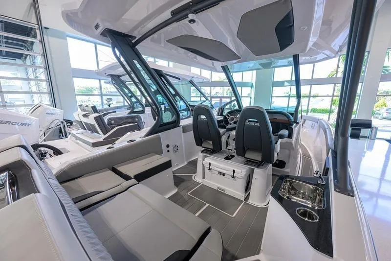 Slide: The Image of 2026 Monterey Elite 25 OB boat interior with modern seating and sleek design. - 6