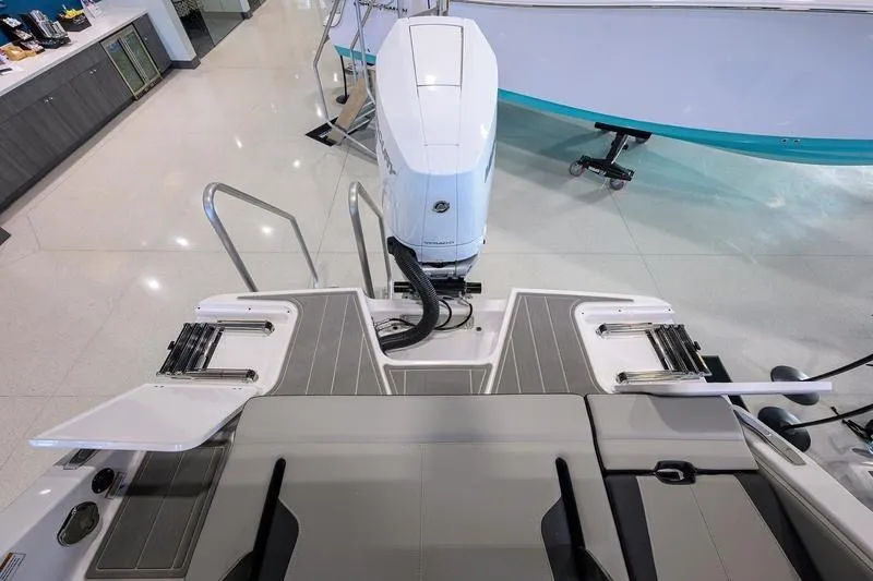 Slide: The Image of 2026 Monterey Elite 25 OB boat with sleek deck and powerful outboard motor. - 8