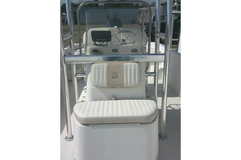 Slide: The Image of 2013 Carolina Skiff 218 DLV boat interior with white seating and steering console. - 12