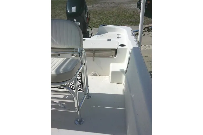 Slide: The Image of 2013 Carolina Skiff 218 DLV boat interior with seating and motor. - 14