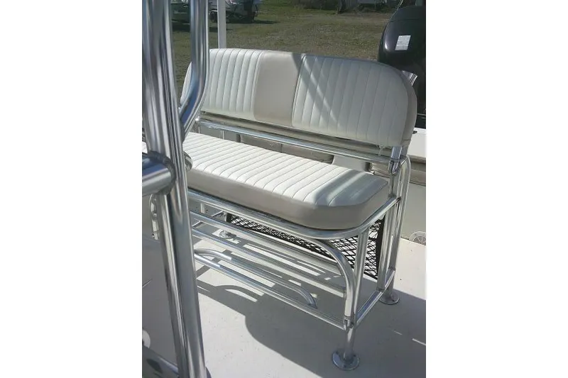Slide: The Image of 2013 Carolina Skiff 218 DLV boat seat with white cushioned upholstery and metal frame. - 15