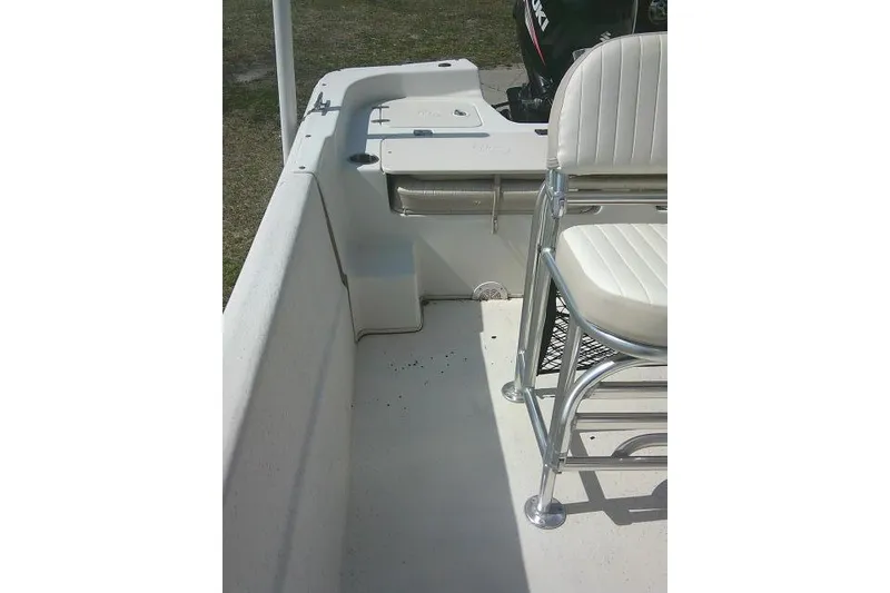 Slide: The Image of 2013 Carolina Skiff 218 DLV boat interior with seating and motor view. - 17