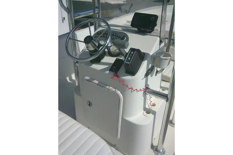 Slide: The Image of 2013 Carolina Skiff 218 DLV boat console with steering wheel and controls. - 18