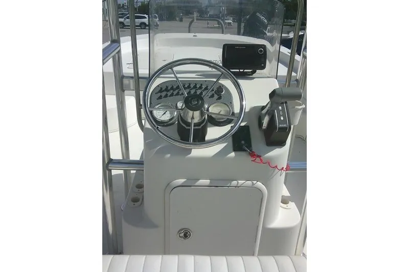 Slide: The Image of 2013 Carolina Skiff 218 DLV boat console with steering wheel and controls. - 22