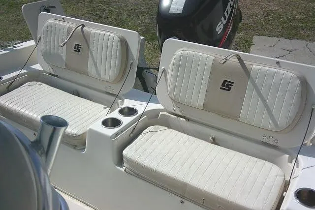 Slide: The Image of 2013 Carolina Skiff 218 DLV boat seats with cup holders and Suzuki outboard motor. - 24
