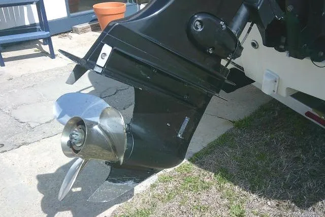 Slide: The Image of 2013 Carolina Skiff 218 DLV boat motor and propeller on display outdoors. - 8
