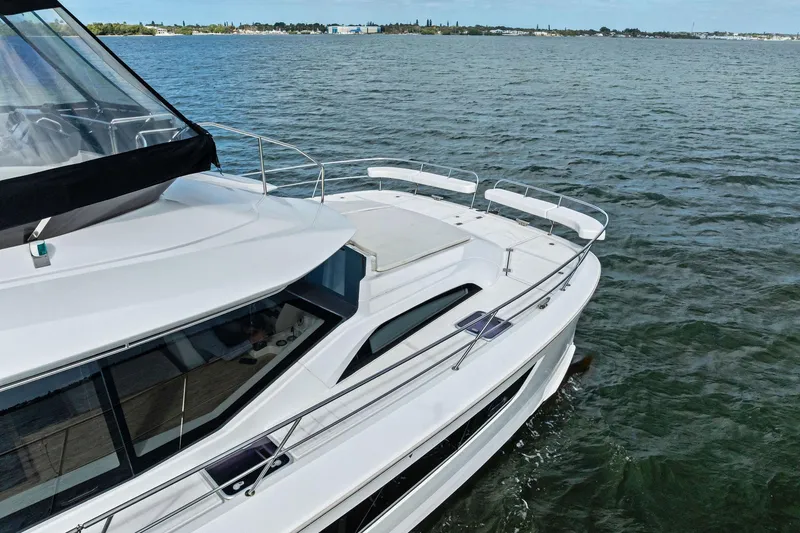 Slide: The Image of 2021 Aquila 44 Yacht cruising on open water, showcasing sleek design and spacious deck. - 12