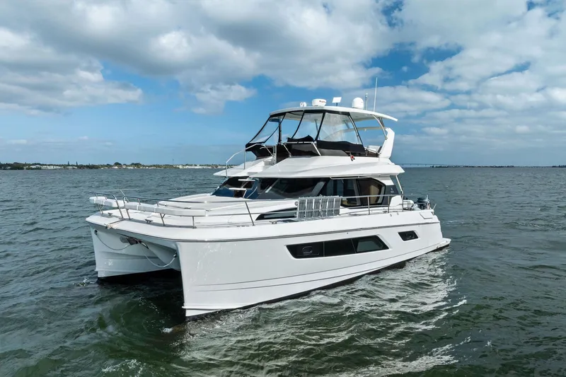 Slide: The Image of 2021 Aquila 44 Yacht cruising on open water under a partly cloudy sky. - 13