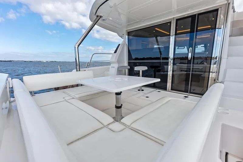 Slide: The Image of Luxurious 2021 Aquila 44 Yacht with spacious outdoor seating and ocean view. - 14