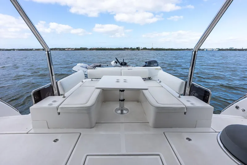 Slide: The Image of Aquila 44 Yacht 2021 rear deck with seating and table, overlooking calm waters. - 18