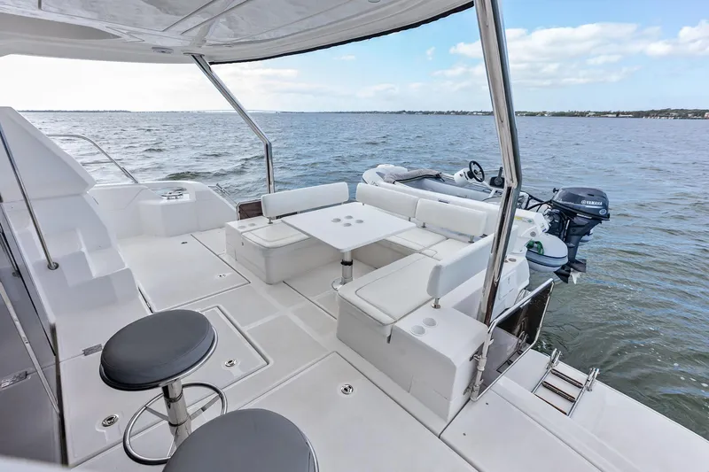 Slide: The Image of Aquila 44 Yacht 2021 deck with seating, table, and ocean view. - 20