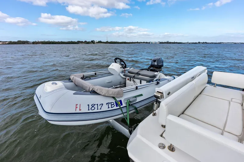 Slide: The Image of Aquila 44 Yacht 2021 with attached inflatable boat on calm waters. - 21