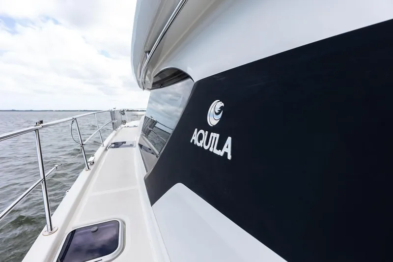Slide: The Image of Side view of 2021 Aquila 44 Yacht on open water. - 29