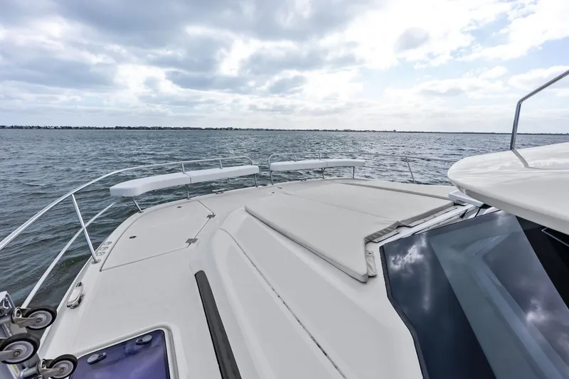 Slide: The Image of Aquila 44 Yacht 2021 cruising on open water under cloudy skies. - 32