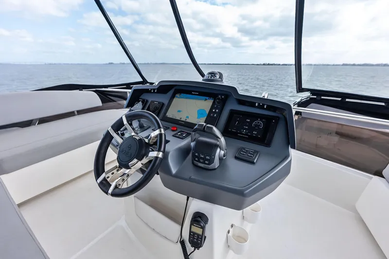 Slide: The Image of Cockpit of 2021 Aquila 44 Yacht with navigation screens and steering wheel. - 36