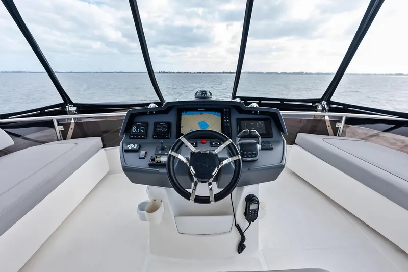 Slide: The Image of Cockpit of 2021 Aquila 44 Yacht with modern navigation controls and panoramic view. - 37
