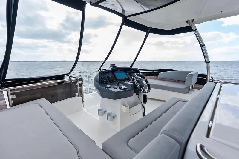 Slide: The Image of Luxurious 2021 Aquila 44 Yacht helm with panoramic ocean view and modern controls. - 38